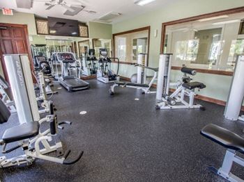 a fitness center with treadmills and other exercise equipment